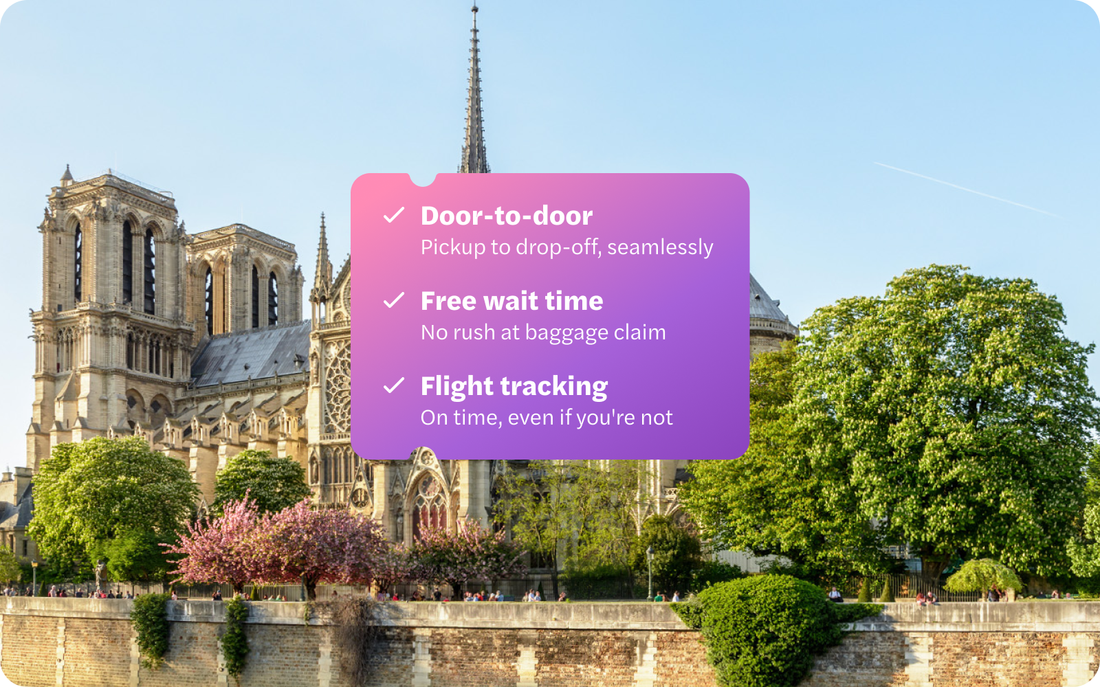 Notre Dame Cathedral with trees along the Seine River in Paris.