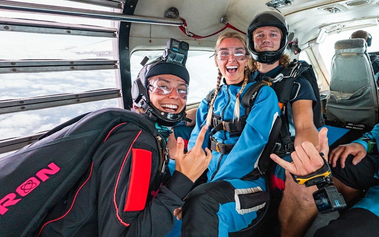 Skydivers in plane preparing for tandem jump over Sydney.