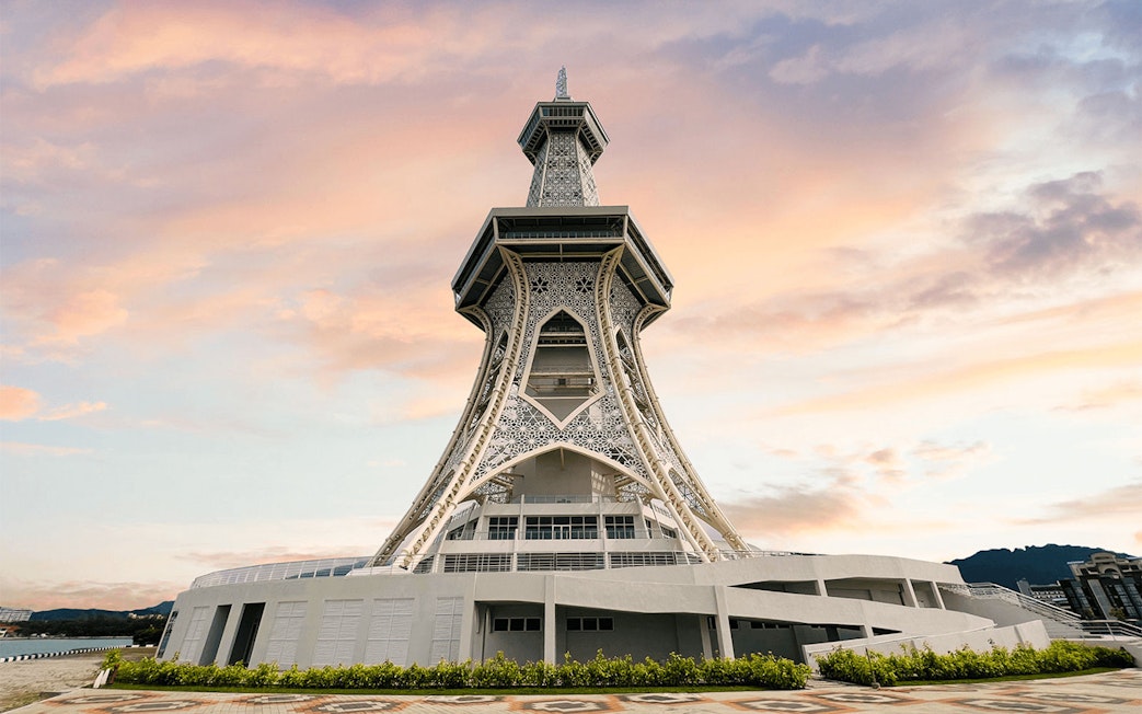 Maha Tower in Malaysia at sunset with intricate architectural design.
