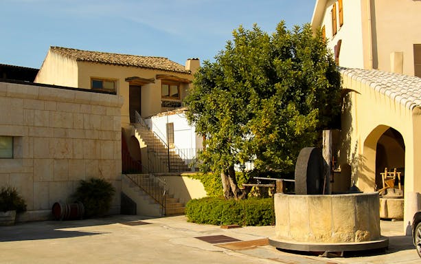 Courtyard view of Argiolas Winery in Serdiana with traditional stone structures.