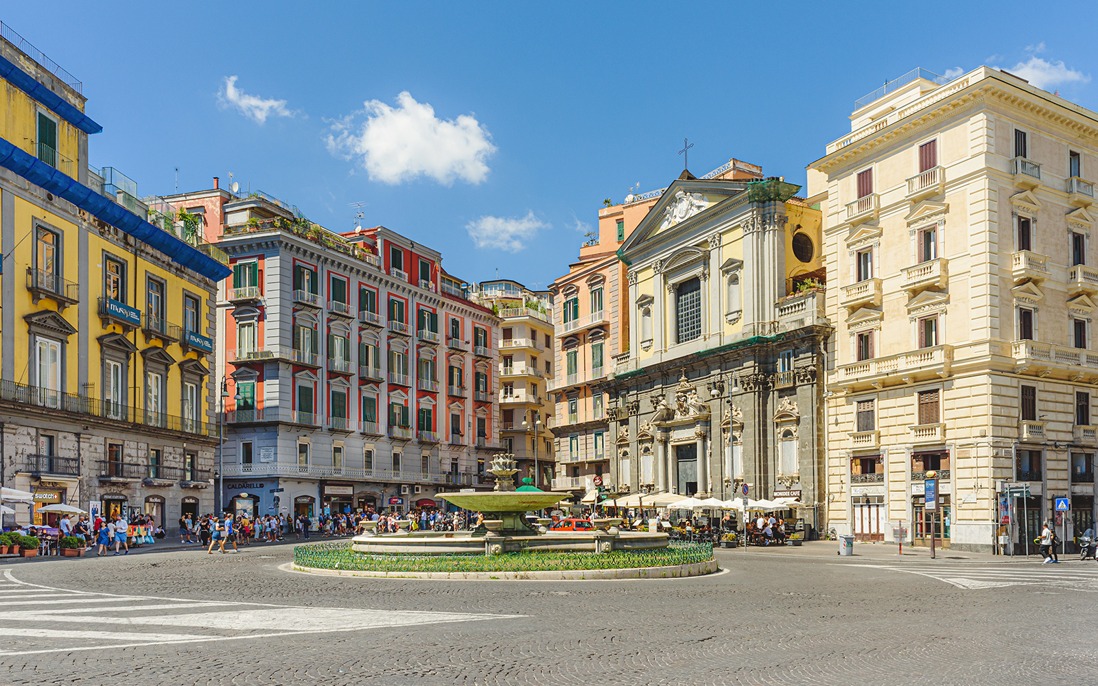 Trieste e Trento Square with artichoke fountain in background on a sunny day, Naples, Italy.