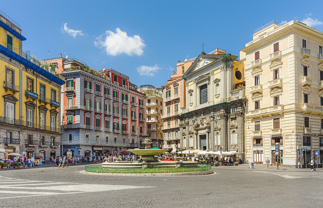 Trieste e Trento Square with artichoke fountain in background on a sunny day, Naples, Italy.