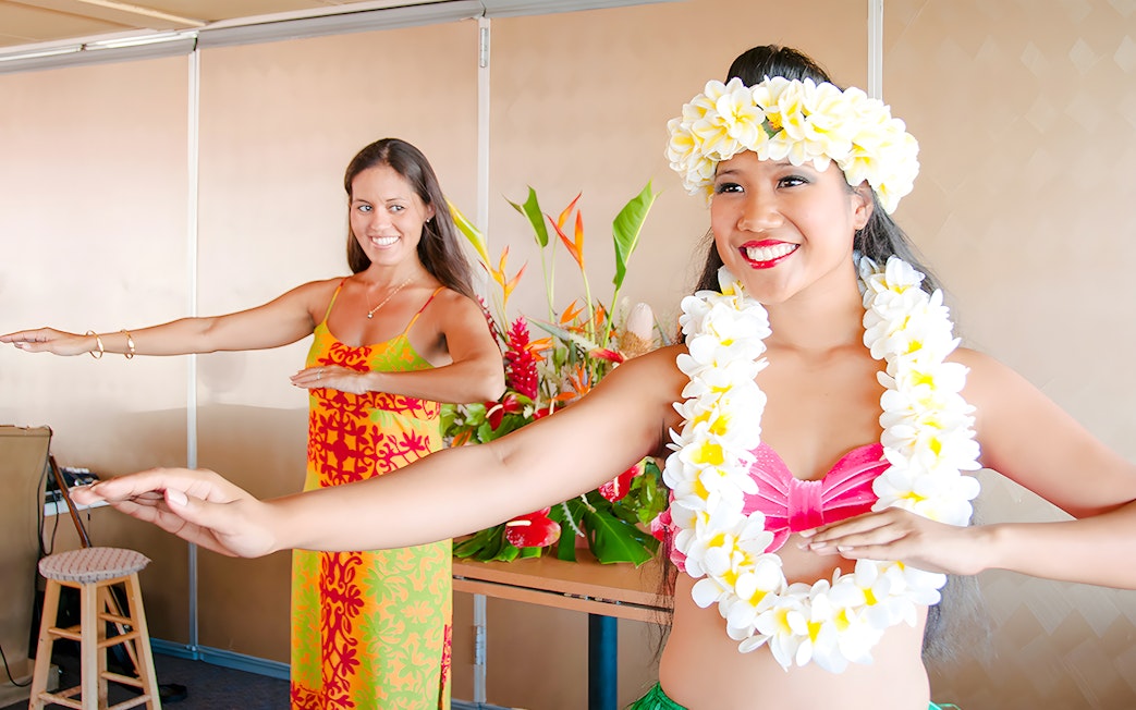 Two women perform hula dance on Star of Honolulu cruise.