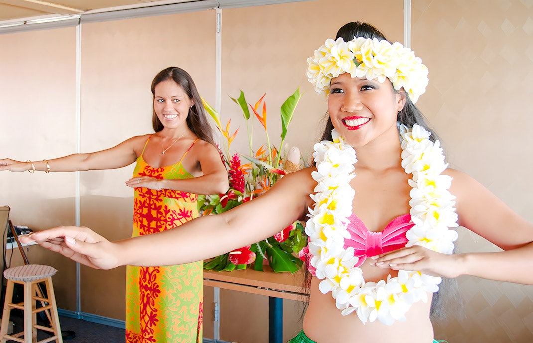 Two women perform hula dance on Star of Honolulu cruise.