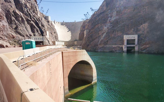 Hoover Dam with view of lower banks and Colorado River.