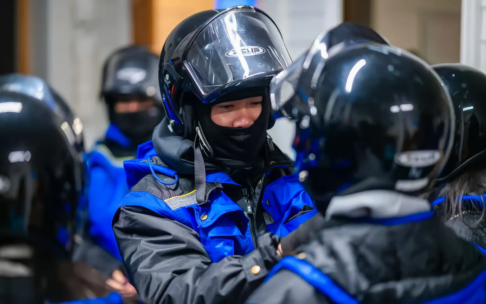 Snowmobile riders preparing for a day trip in Tromso, wearing helmets and winter gear.