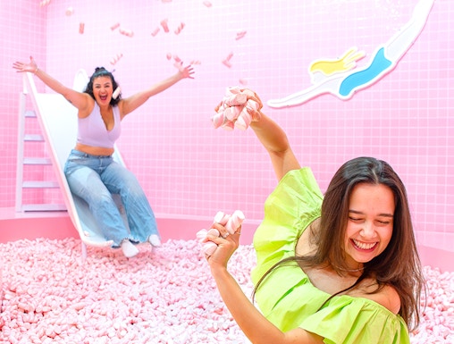 Two people enjoying a marshmallow pool at Wondr Experience.