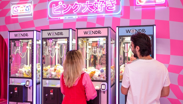 People playing claw machines at WONDR Experience, Amsterdam.