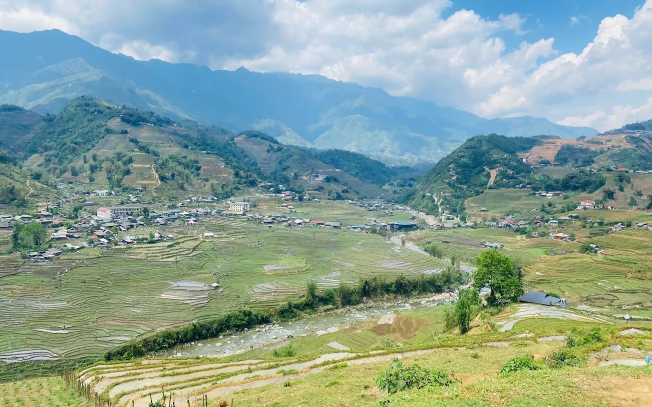 Terraced rice fields and village in Sapa, Vietnam, viewed from a motorbike tour route.