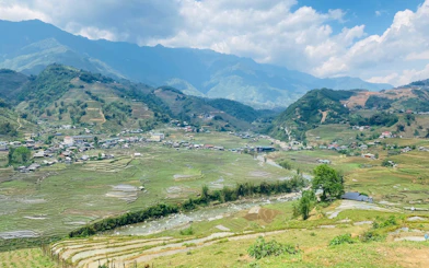 Terraced rice fields and village in Sapa, Vietnam, viewed from a motorbike tour route.