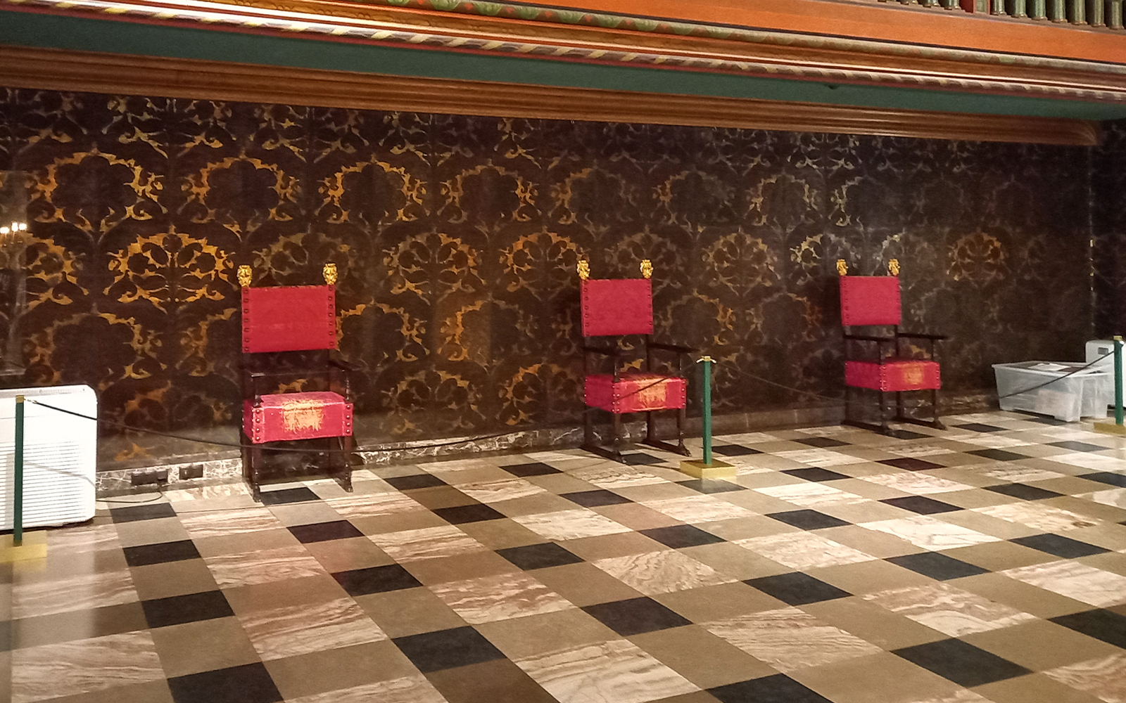 Three ornate chairs in a room at Wawel Castle, Krakow, Poland.