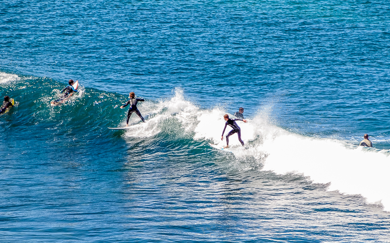 Surfer riding a wave at Bells Bay, showcasing the popular surfing destination.