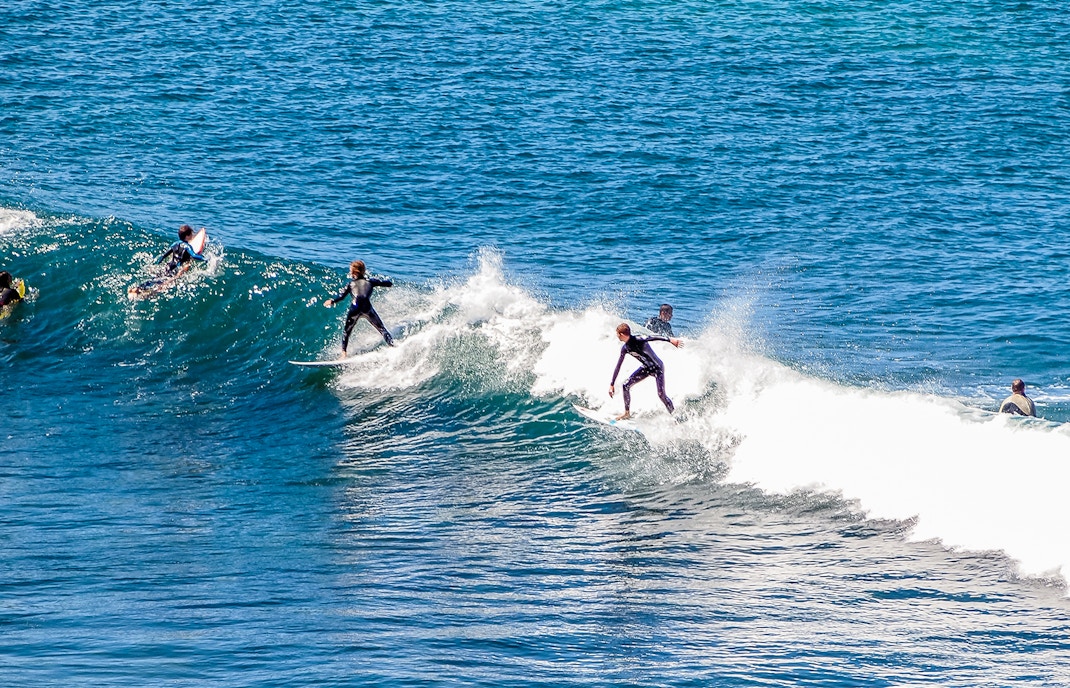 Surfer riding a wave at Bells Bay, showcasing the popular surfing destination.
