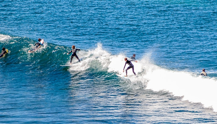 Surfer riding a wave at Bells Bay, showcasing the popular surfing destination.
