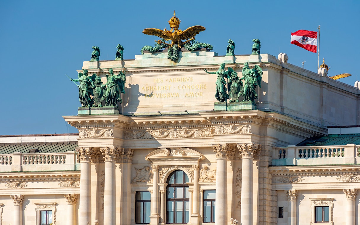 Hofburg Palace facade with Austrian flag, Vienna.