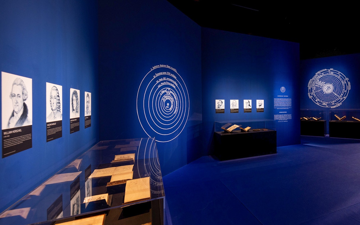 Exhibition room with historical portraits and books at Singapore Future World Exhibition.