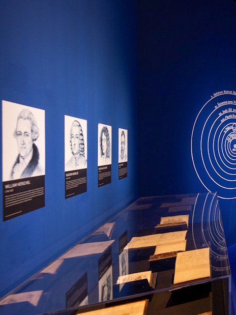 Exhibition room with historical portraits and books at Singapore Future World Exhibition.