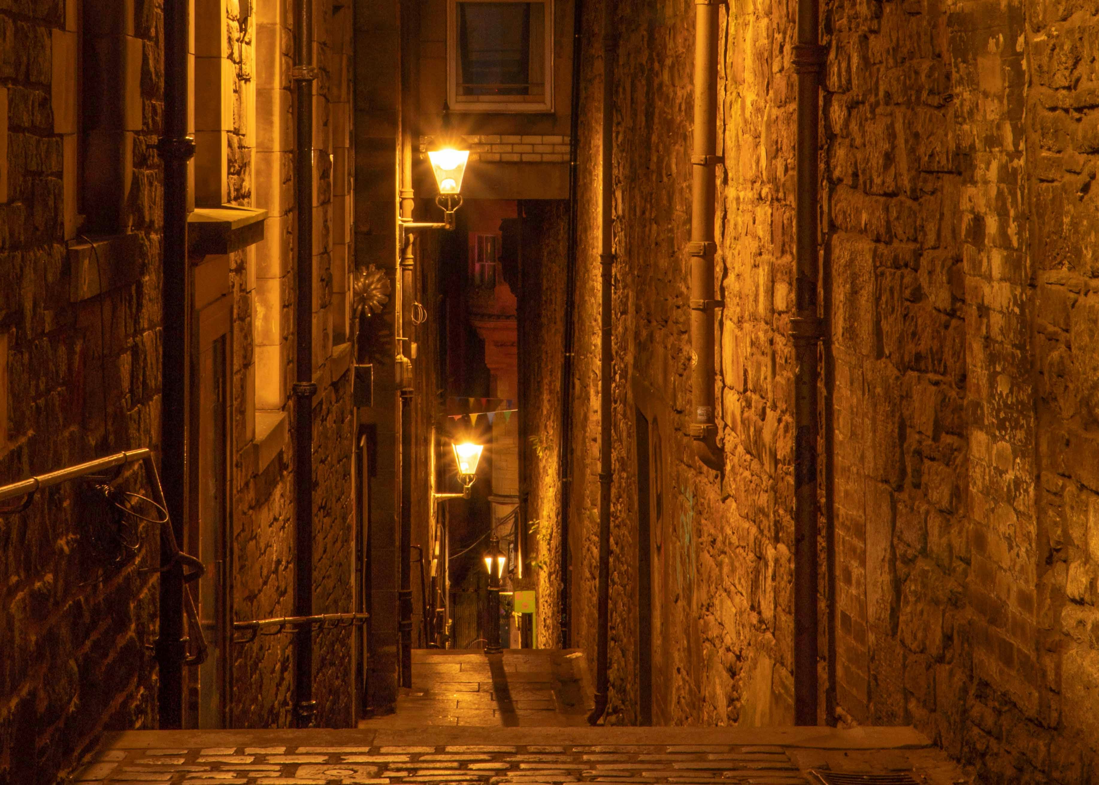 Narrow alleyway with stone walls and warm lighting at The Real Mary King’s Close, Edinburgh.