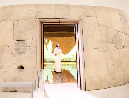 Visitors exploring ancient artifacts at Zayed National Museum exhibit, Abu Dhabi.