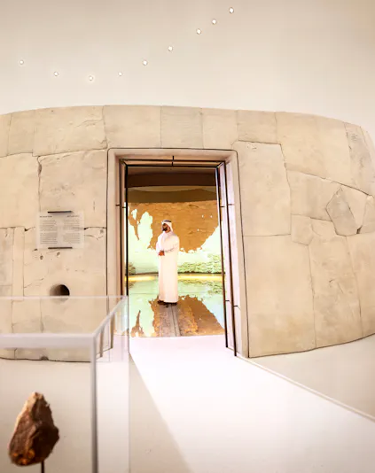 Visitors exploring ancient artifacts at Zayed National Museum exhibit, Abu Dhabi.