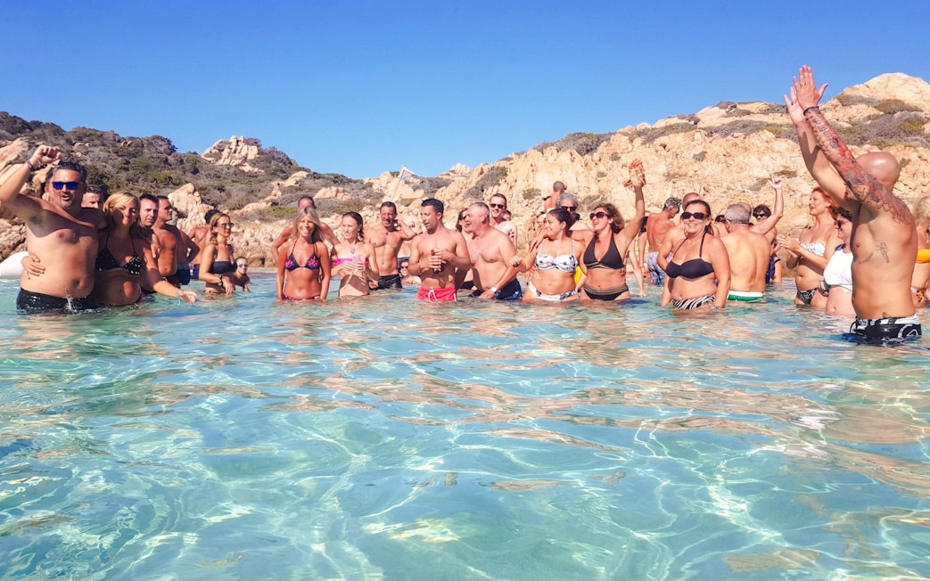Group enjoying water on catamaran tour in La Maddalena Archipelago.