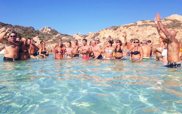 Group enjoying water on catamaran tour in La Maddalena Archipelago.