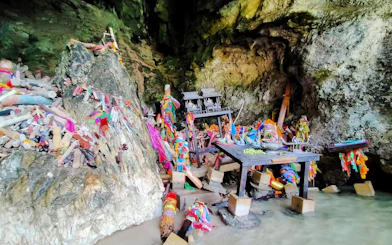 Shrine with colorful offerings inside a cave on the Krabi 7 Islands Sunset Tour.
