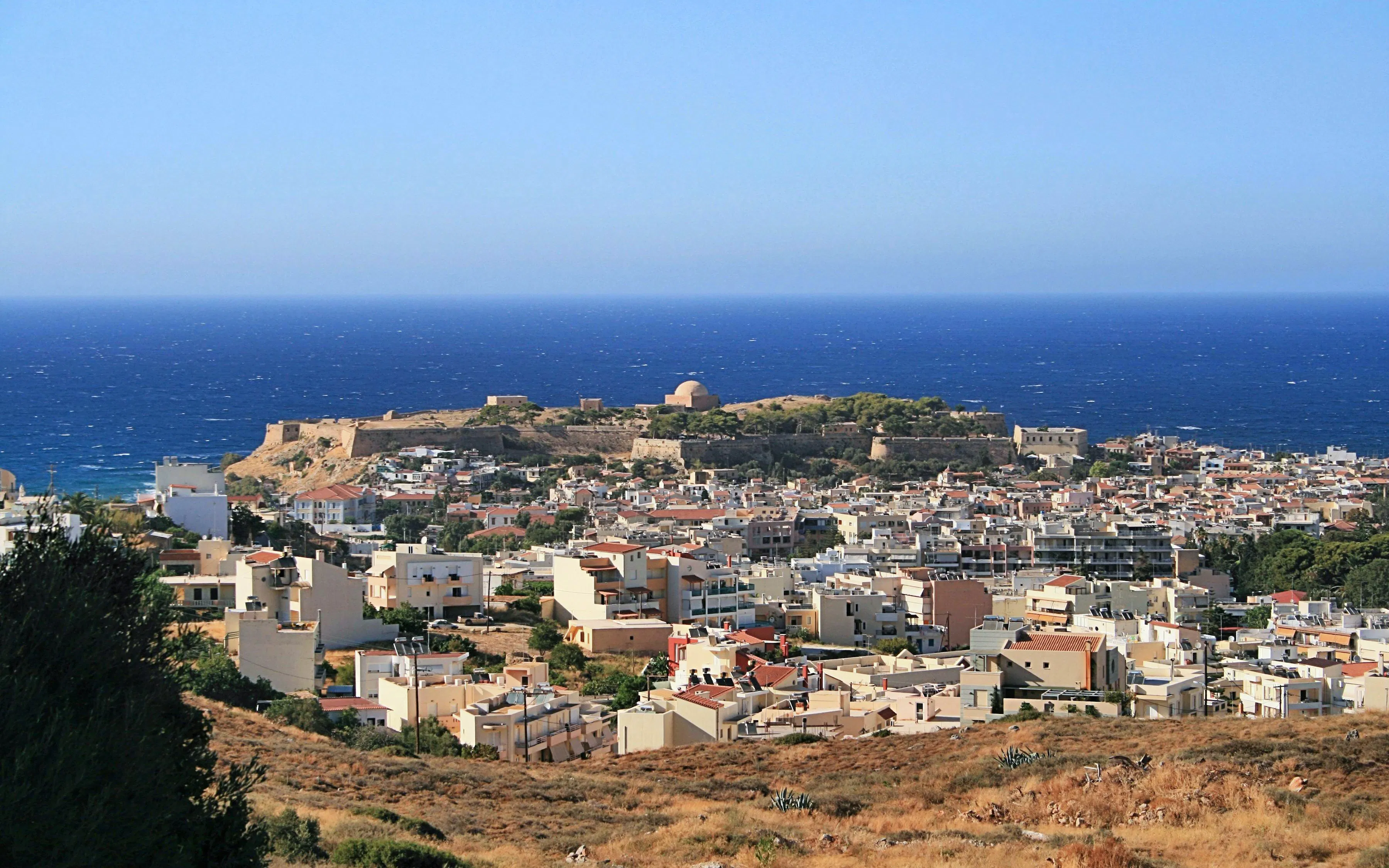 Aerial view of Rethymno city with Fortezza Castle and the Mediterranean Sea in the background.