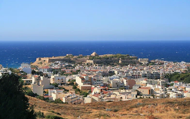 Aerial view of Rethymno city with Fortezza Castle and the Mediterranean Sea in the background.