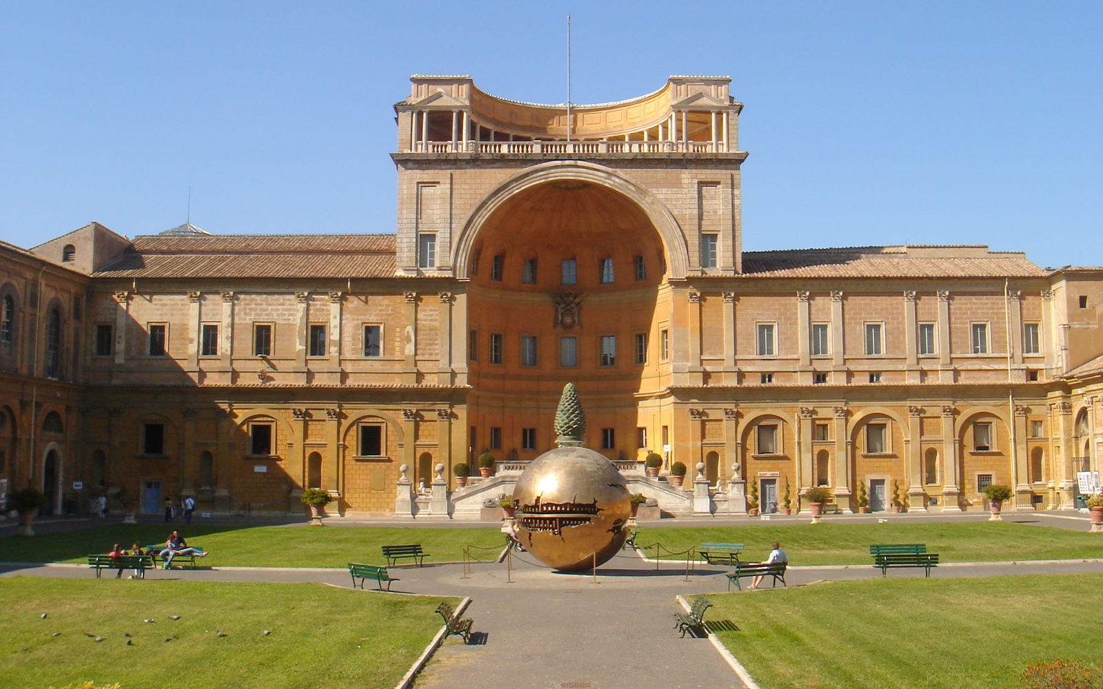 Vatican Museum exterior with bronze spherical sculpture in courtyard, Rome, Italy.