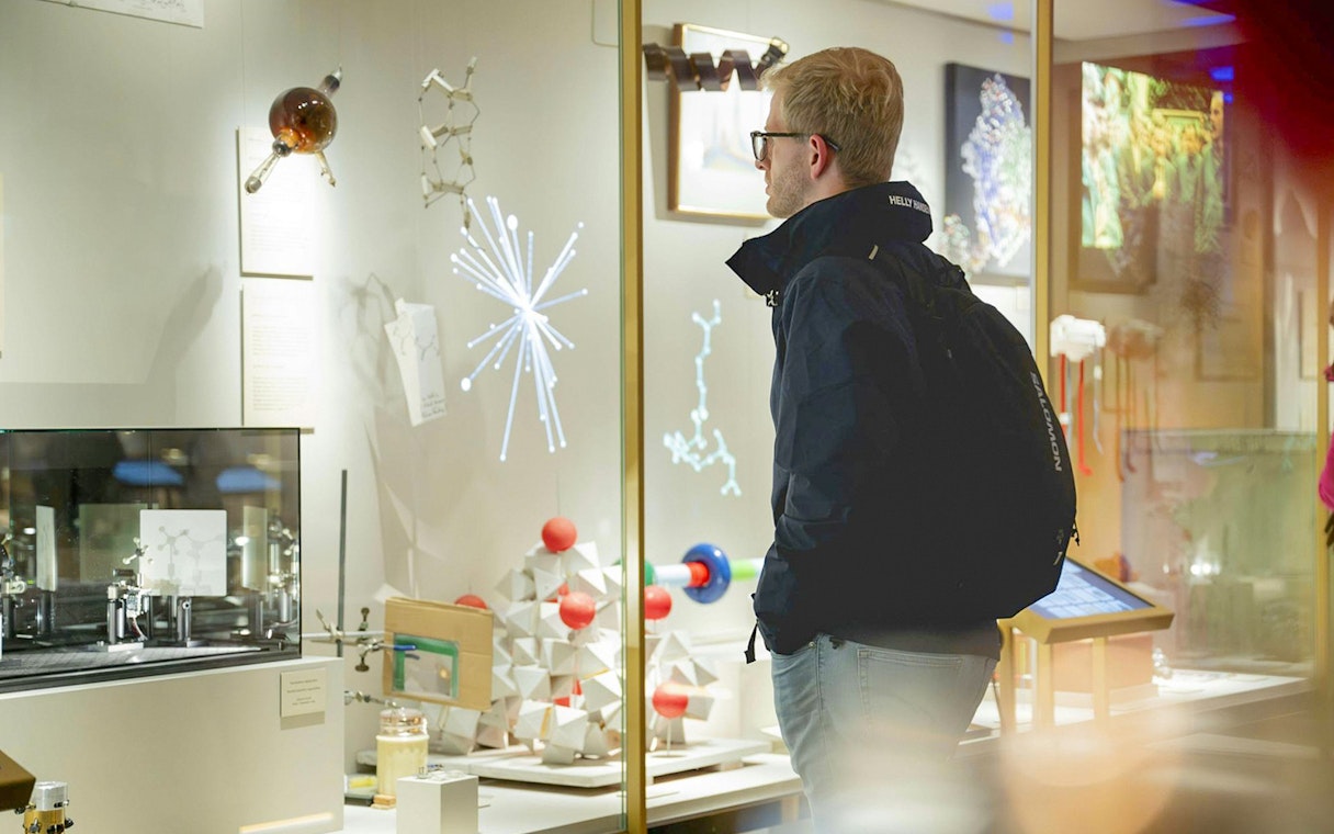 Visitor observing scientific exhibits at the Nobel Prize Museum.