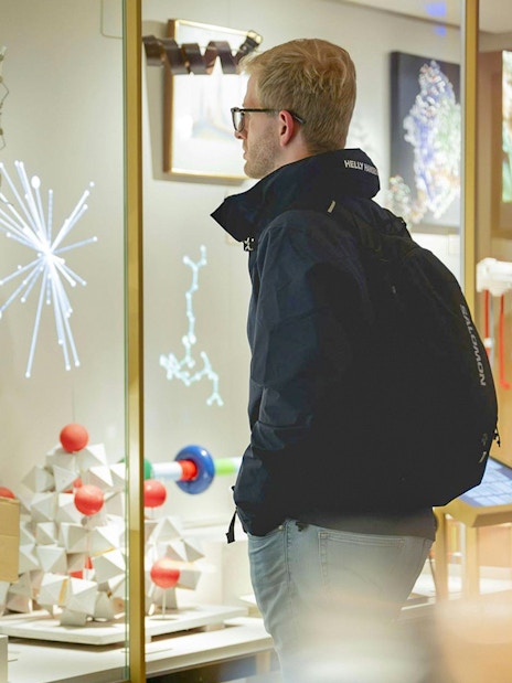 Visitor observing scientific exhibits at the Nobel Prize Museum.