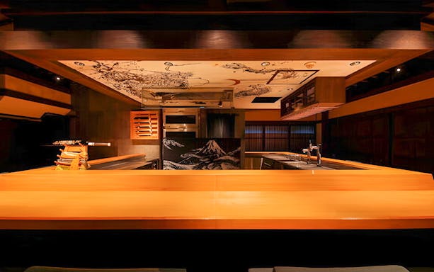 Yakitori Tsukiya interior with traditional decor for 6/9-course yakitori meal experience.