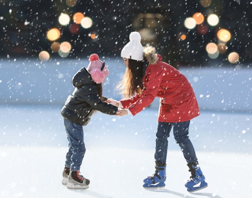 Children ice skating in Krakow during New Year celebrations.