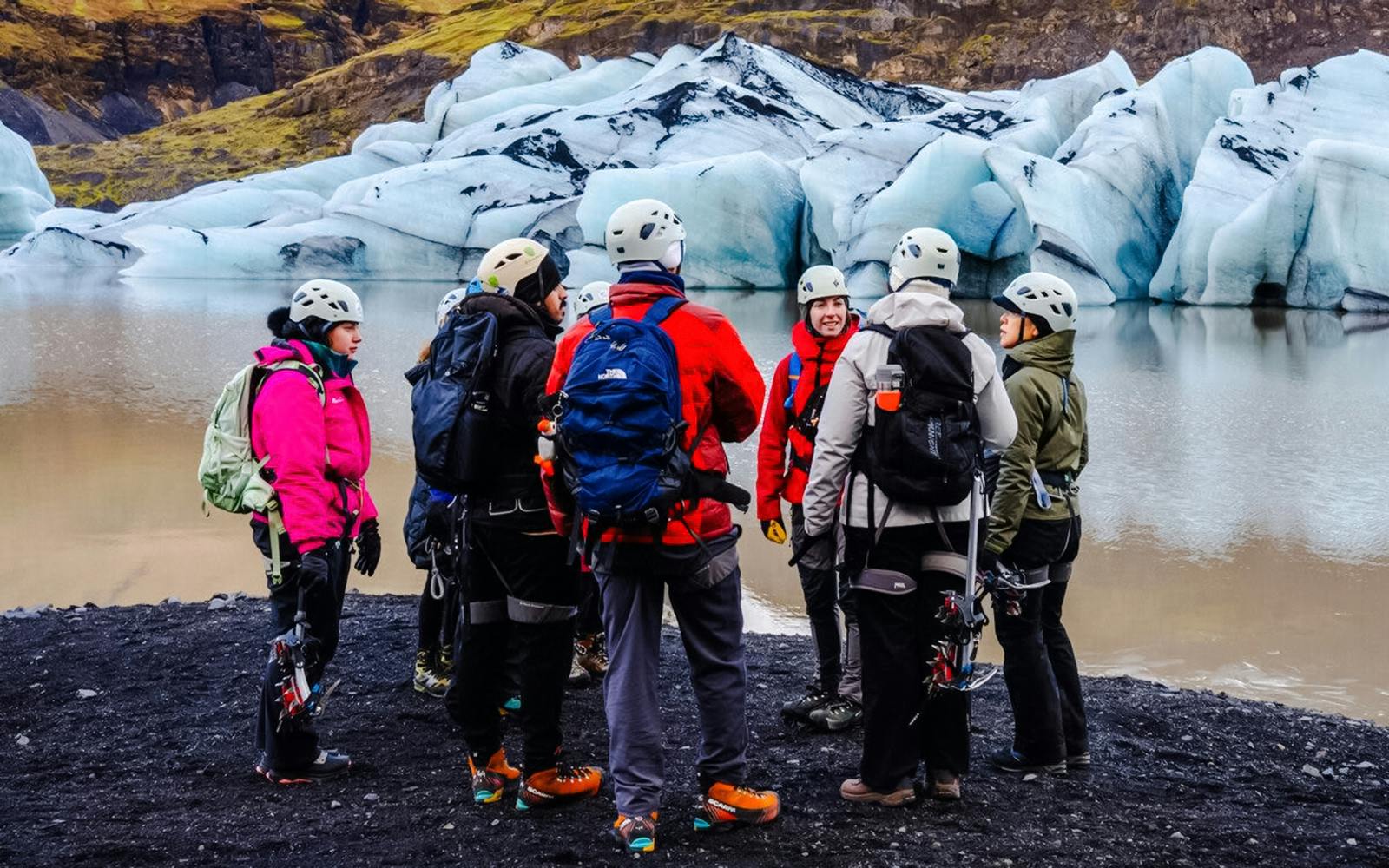 Guests gathered with gear at Sólheimajökull glacier, Iceland.