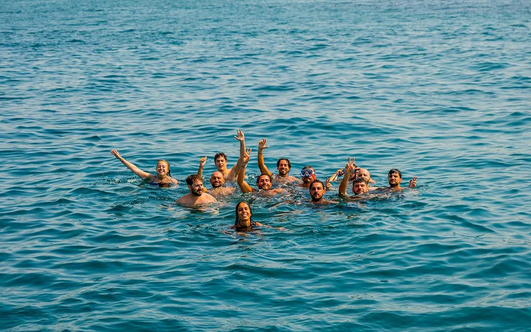 Tourists swimming in the sea during a cruise party in Mallorca.