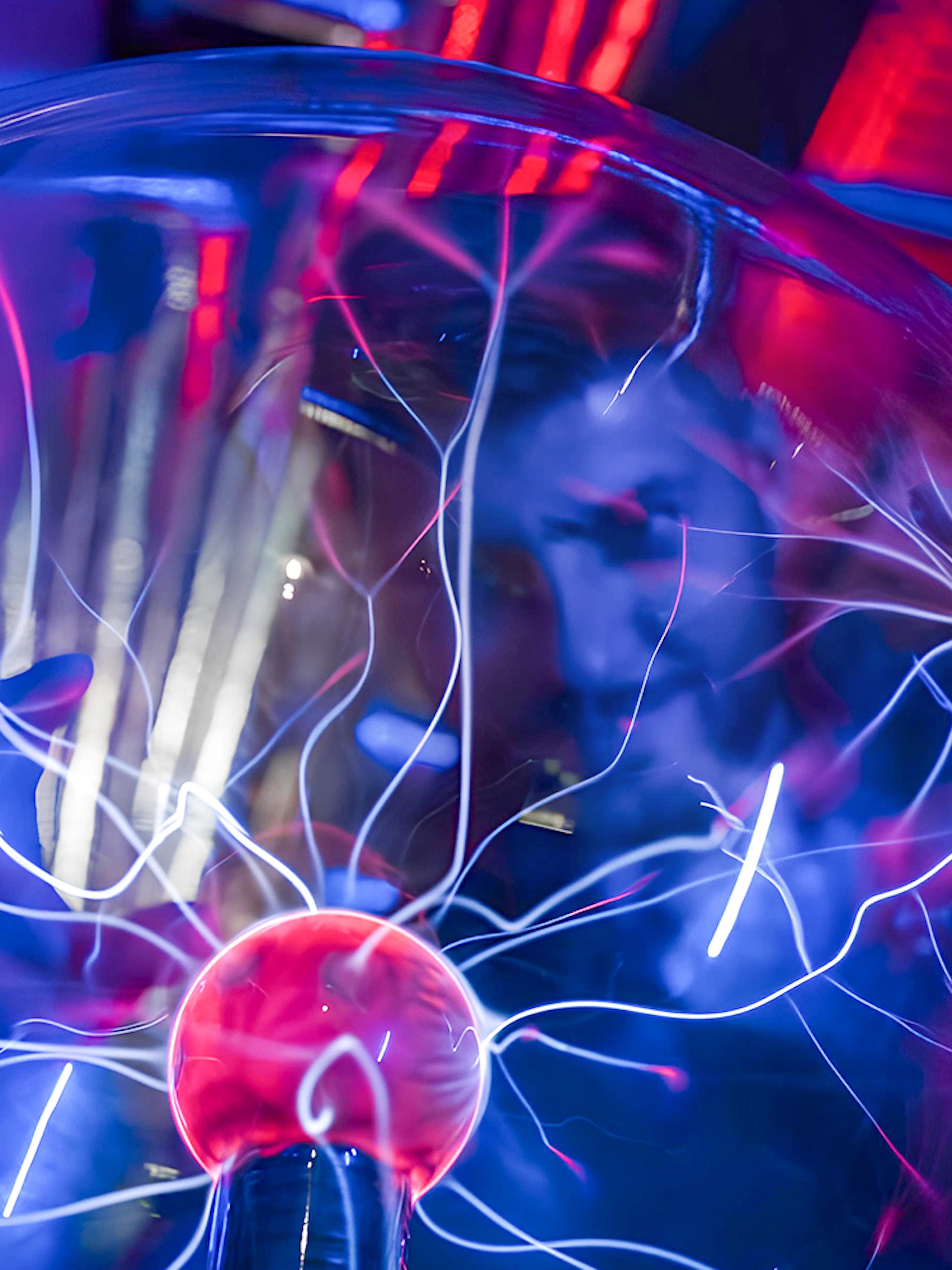 Plasma ball exhibit at DeJa Vu Museum with electric arcs.
