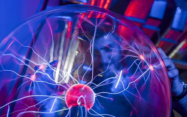 Plasma ball exhibit at DeJa Vu Museum with electric arcs.