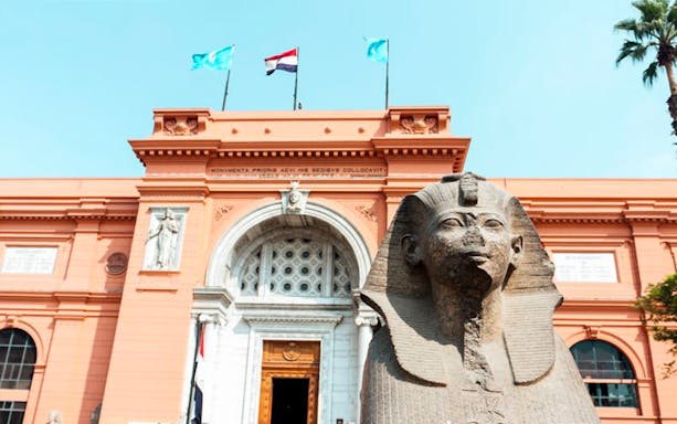 Egyptian Museum entrance with ancient statue, Cairo, part of guided day tour from Hurghada.