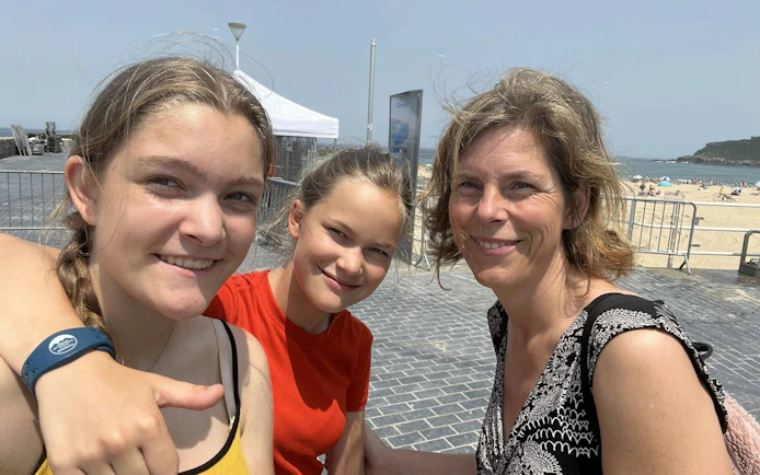 Family enjoying a sunny day at the beach in San Sebastian during a self-guided city exploration game.