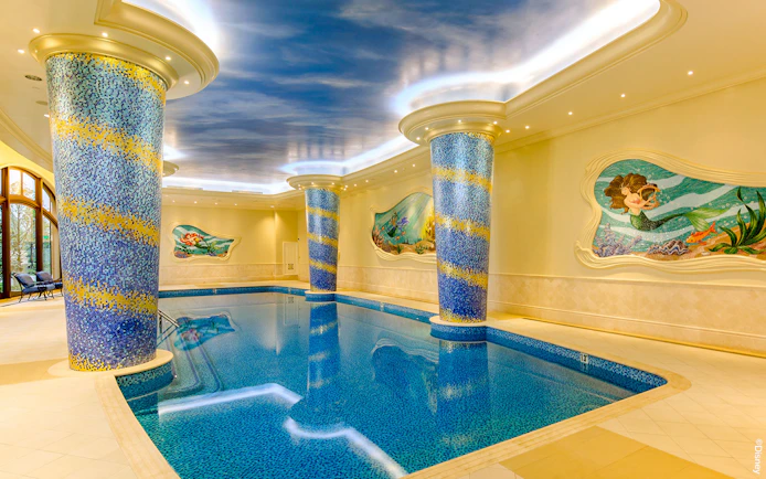 Indoor pool with mosaic columns and mermaid mural at Shanghai Disney.