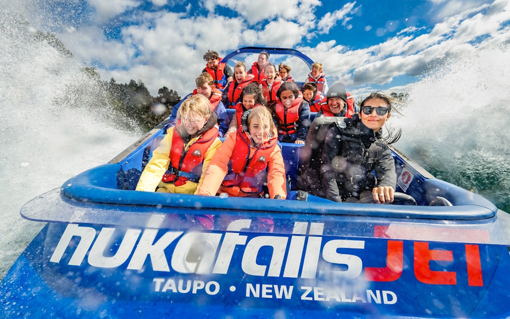 Tourists on a jet boat ride at Huka Falls, Taupo, New Zealand.