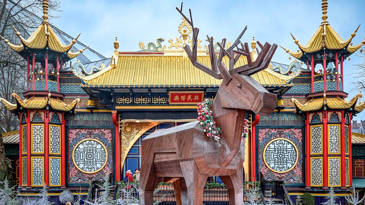 Tivoli Gardens Christmas display with wooden reindeer and Chinese-style pavilion.