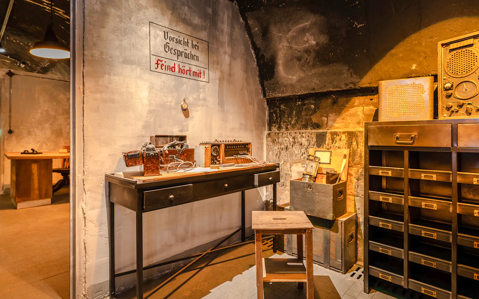 Underground communication room exhibit at Caen Memorial Museum, France, showcasing WWII artifacts.