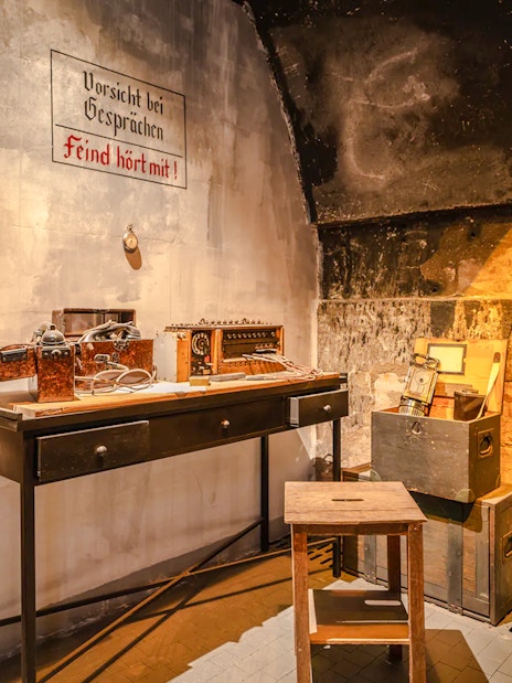 Underground communication room exhibit at Caen Memorial Museum, France, showcasing WWII artifacts.