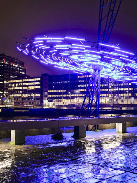 Amsterdam Light Festival installation glowing over canal during small-group cruise.