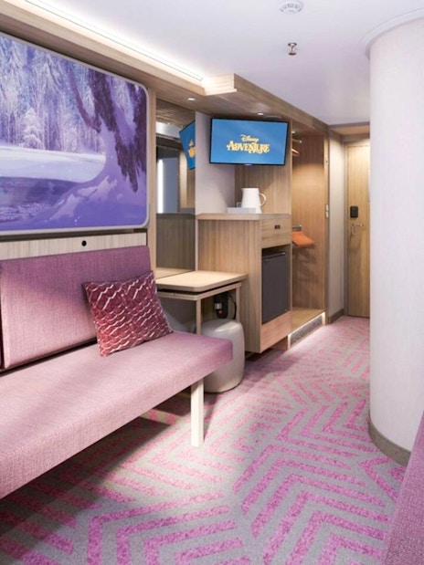 Oceanview Stateroom interior on Disney Adventure Cruise from Singapore, featuring purple seating and Frozen-themed artwork.