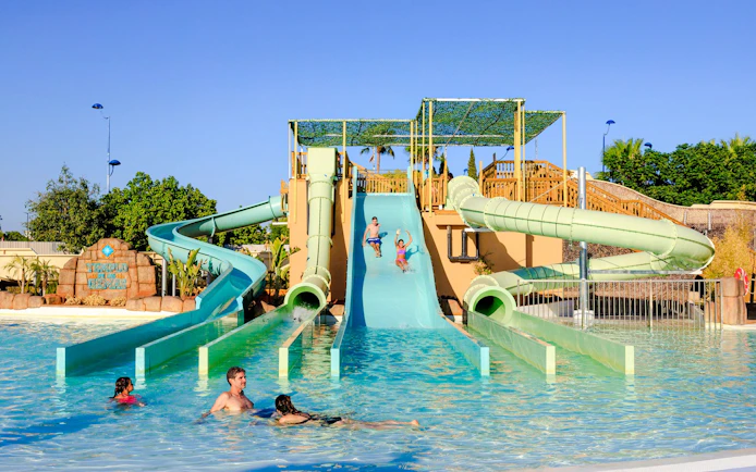 Visitors enjoying water slides at Temple of the Gems, Aqua Magica.