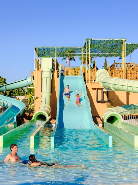 Visitors enjoying water slides at Temple of the Gems, Aqua Magica.