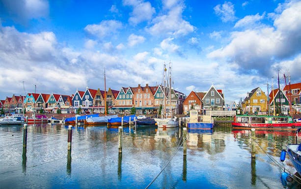Volendam marina with boats docked along the waterfront, showcasing traditional Dutch architecture.